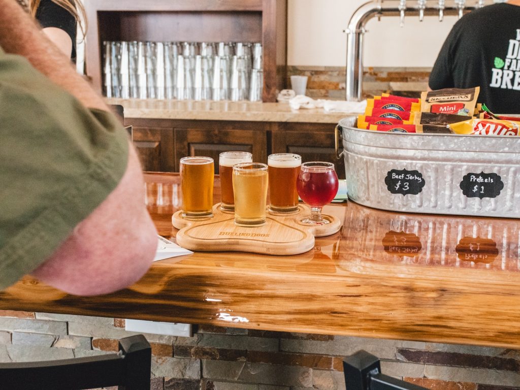 ciders - clear glass jars on brown wooden table